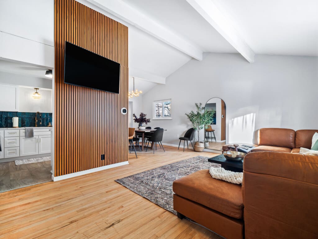 Modern living room with wooden accent wall and mounted TV in an Ohio rental property