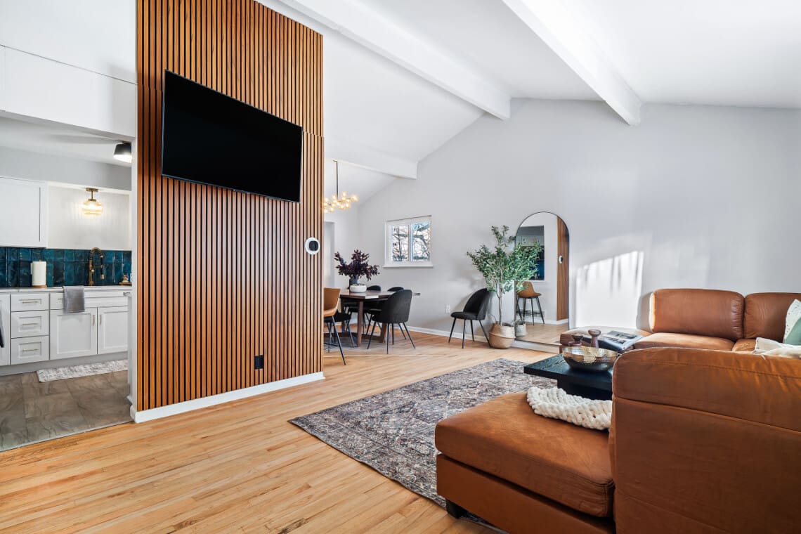 Modern living room with wooden accent wall and mounted TV in an Ohio rental property