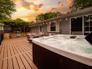 Sunset view from a deck with hot tub overlooking scenic landscape