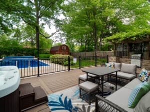 Beautiful backyard featuring a sparkling pool, lush landscaping, and inviting lounge seating—perfect for relaxing or entertaining.