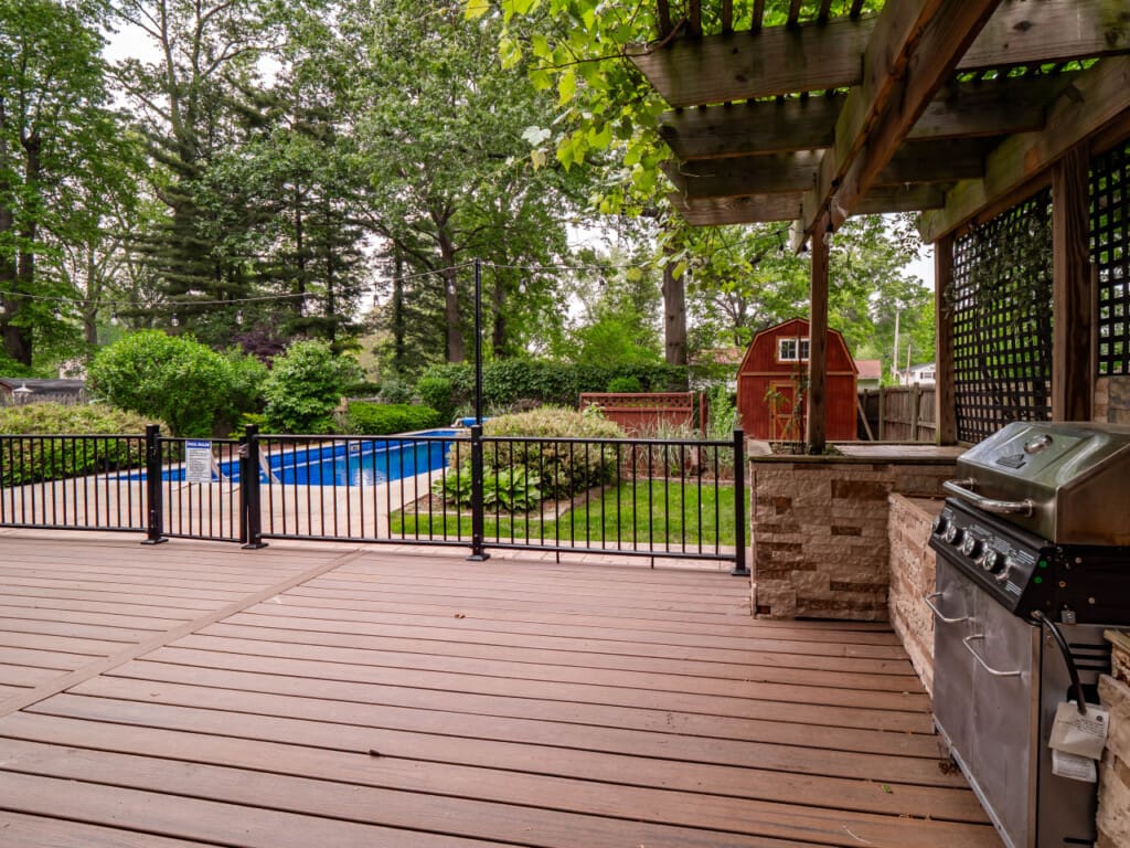 Beautiful backyard with sparkling pool and spacious deck, perfect for relaxing and entertaining guests.
