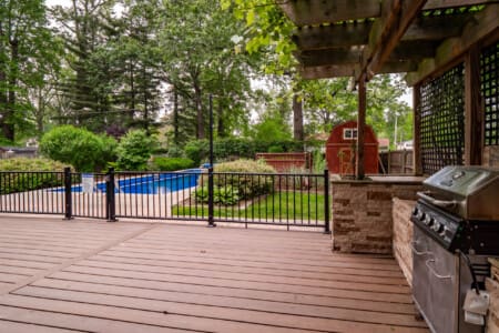 Beautiful backyard with sparkling pool and spacious deck, perfect for relaxing and entertaining guests.