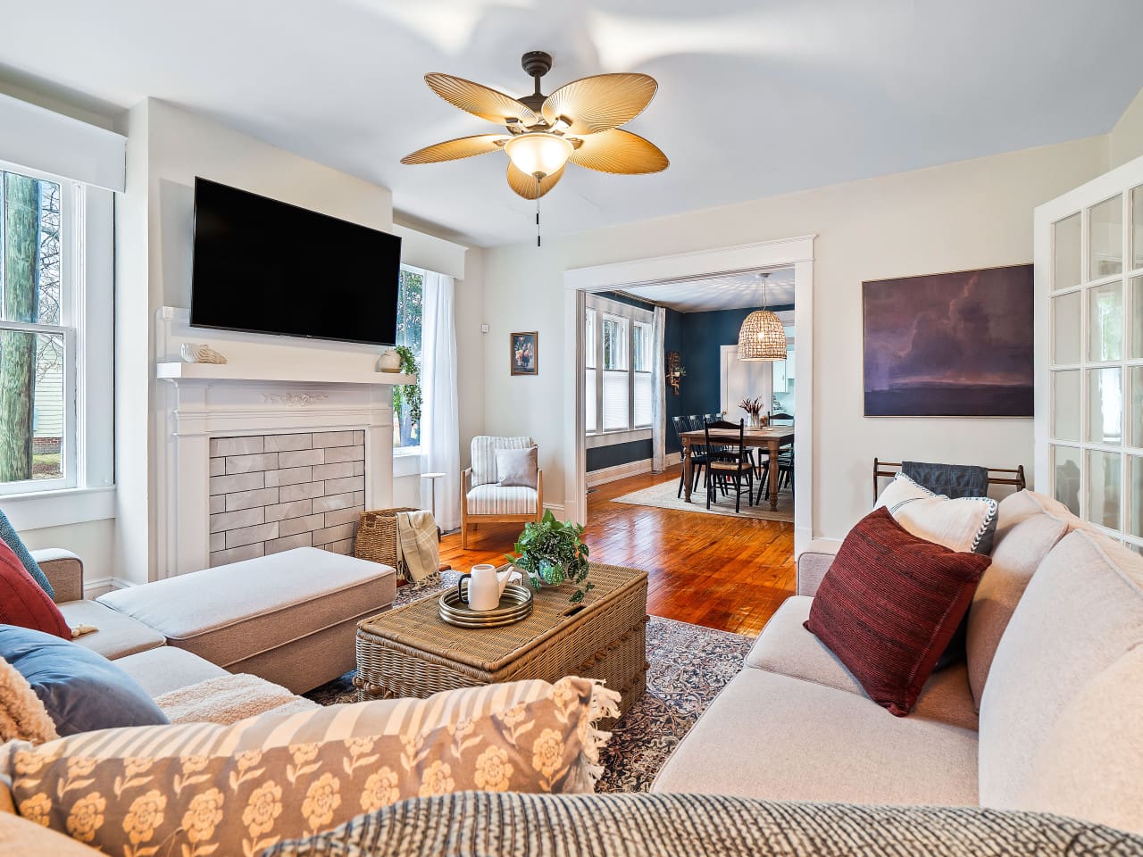 Spacious living room with stylish furniture, ample seating, and a large flatscreen TV for group relaxation and entertainment.