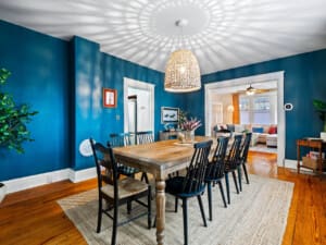 Spacious Dining Room for Family Gatherings in Northeast Ohio Rental Elegant dining room in a Northeast Ohio vacation rental with large family seating and modern overhead lighting.