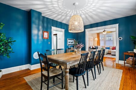 Elegant dining room in a Northeast Ohio vacation rental with large family seating and modern overhead lighting.