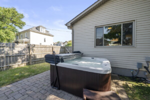 Private backyard hot tub with privacy fence at a romantic Ohio vacation rental.