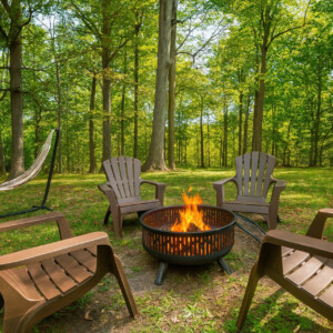 Romantic woodland campfire with chairs arranged around a glowing fire in an Ohio forest setting.