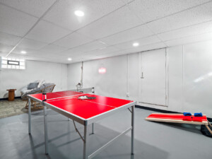 Indoor game room with a ping pong table for family fun during winter travel