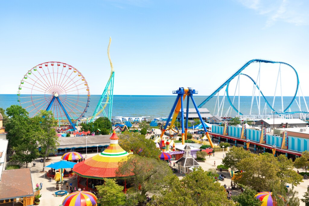 Cedar Point amusement park overlooking Lake Erie with roller coasters, ferris wheel, and summer crowds in Sandusky, Ohio