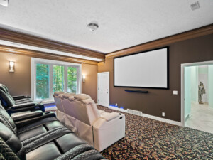 Luxury vacation rental home in Northeast Ohio with a private movie room featuring recliner seating and large-screen entertainment.