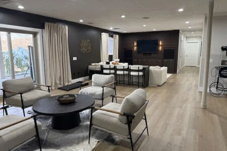 Modern short-term rental living and dining area with vaulted ceilings and open-concept design