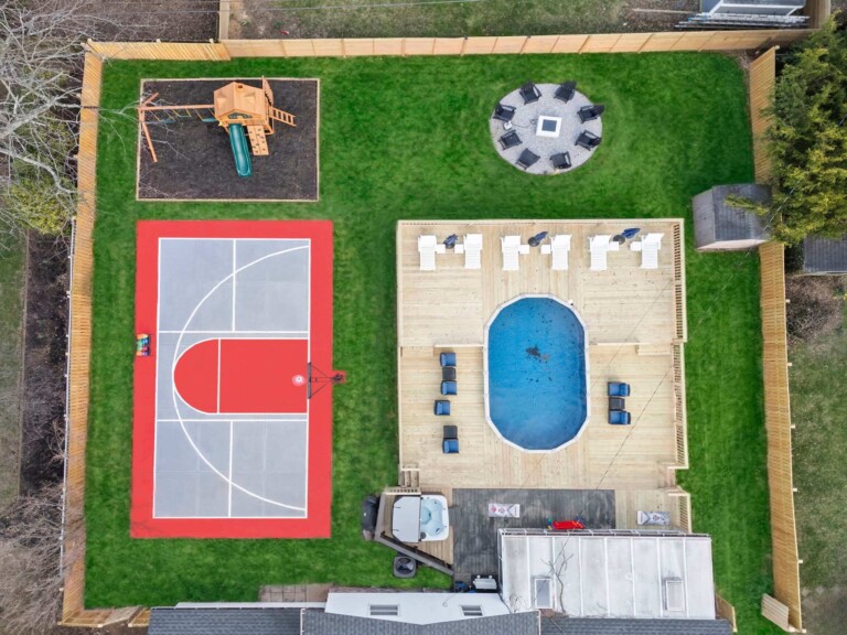 luxury short-term rental backyard with pickleball court, basketball court, firepit, hot tub and playground