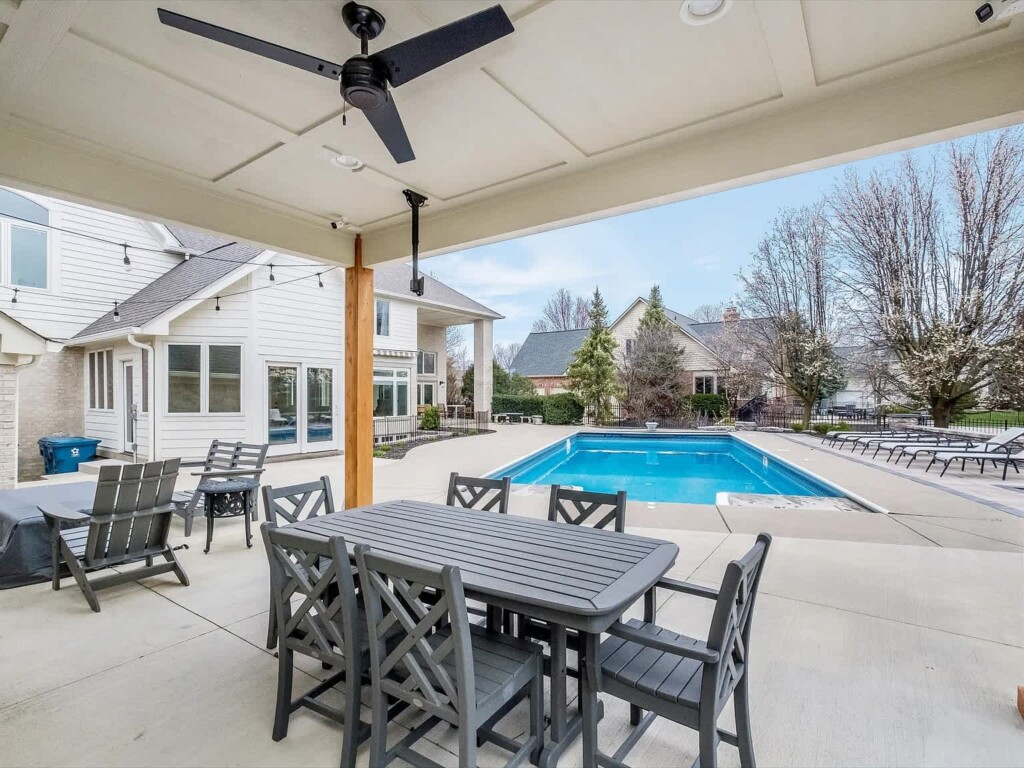 backyard pool with picnic table and family seating area for short term rental