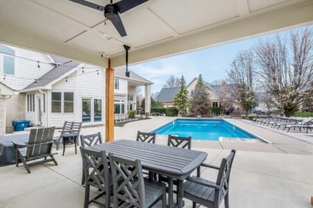 backyard pool with picnic table and family seating area for short term rental