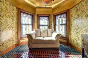historic sitting room with stained glass windows, natural light, and elegant vintage charm