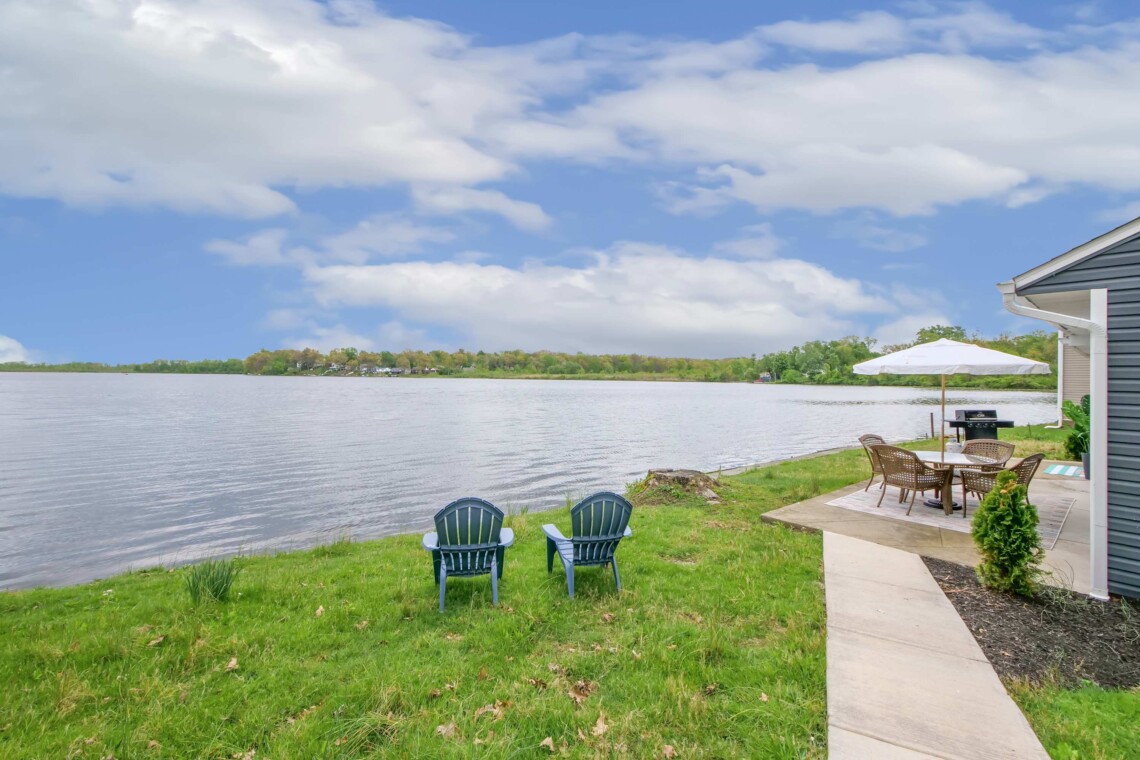 peaceful lakeside retreat with two chairs overlooking a calm Ohio lake at sunset