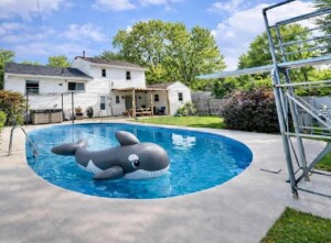 family friendly backyard pool with diving board and Shamu float at Ohio vacation rental