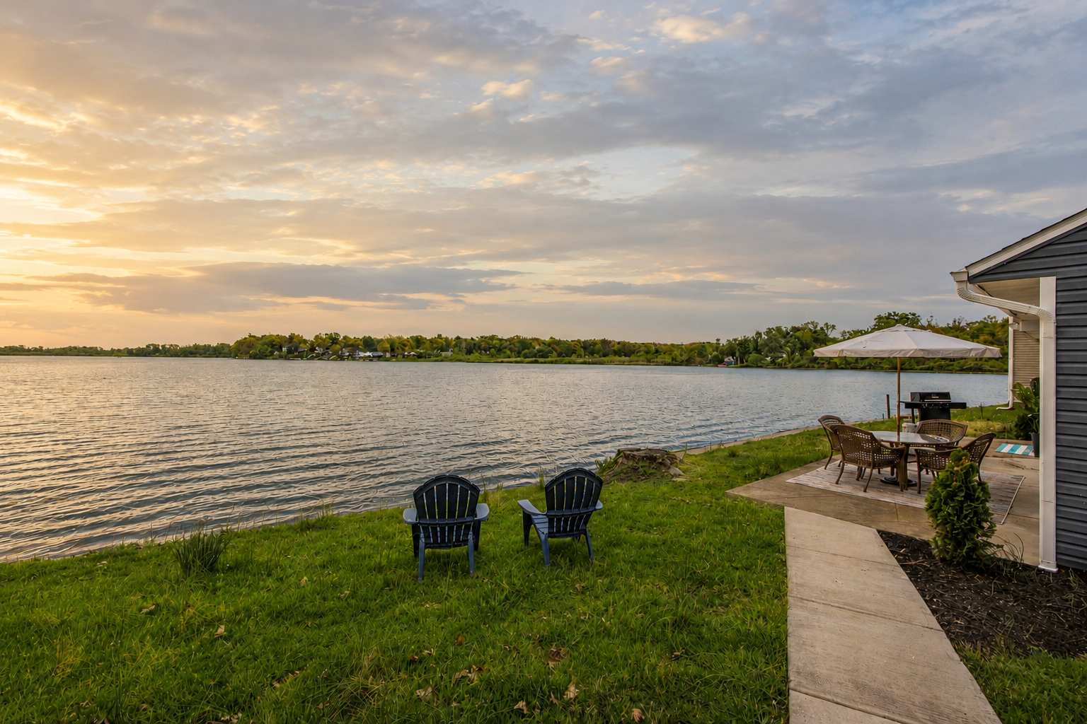 peaceful lakeside retreat with two Adirondack chairs overlooking a scenic Ohio lake at sunset