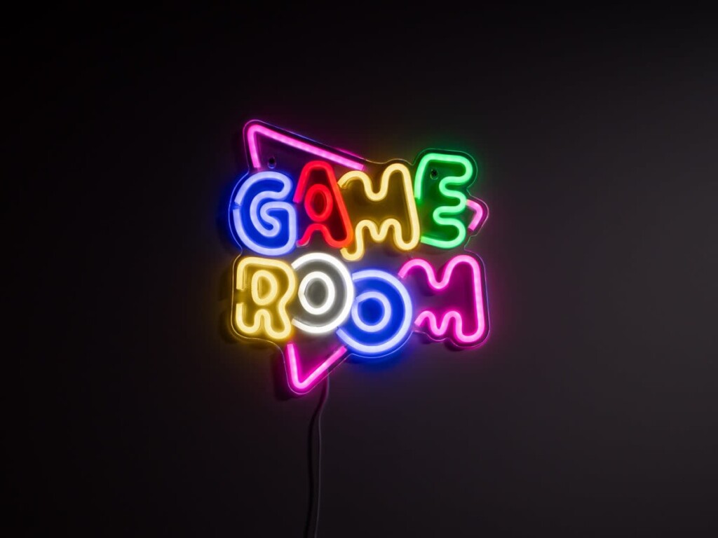 Neon game room sign inside a family-friendly vacation rental entertainment space