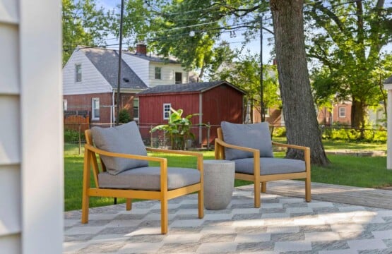 Beautiful outdoor sitting area at a short-term rental surrounded by trees and plants